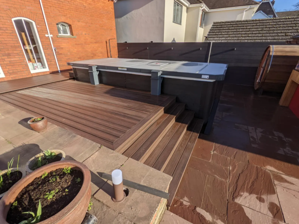 Composite hot tub deck with built-in steps