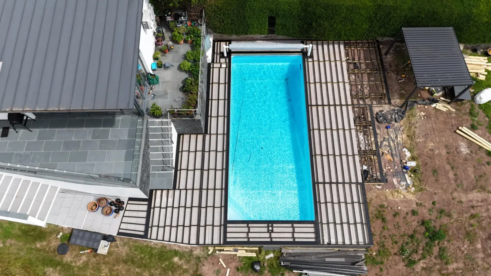 Aerial view of composite decking built around an in-ground swimming pool