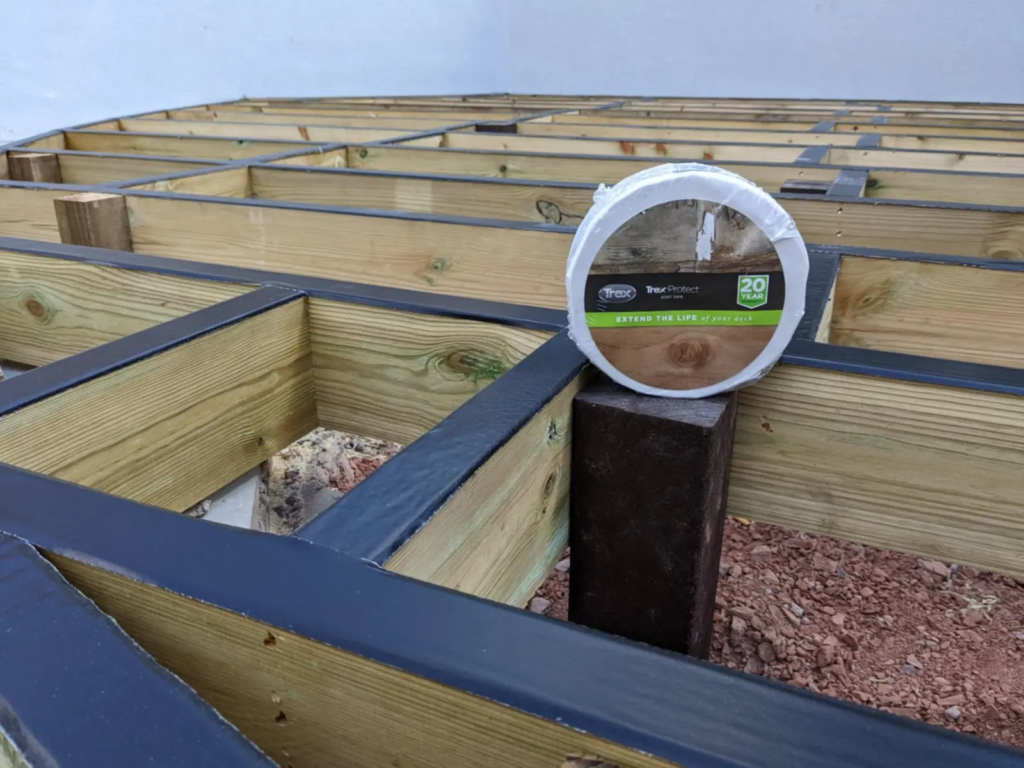 Subframe joists with black joist tape and posts, built by Ellis Decks