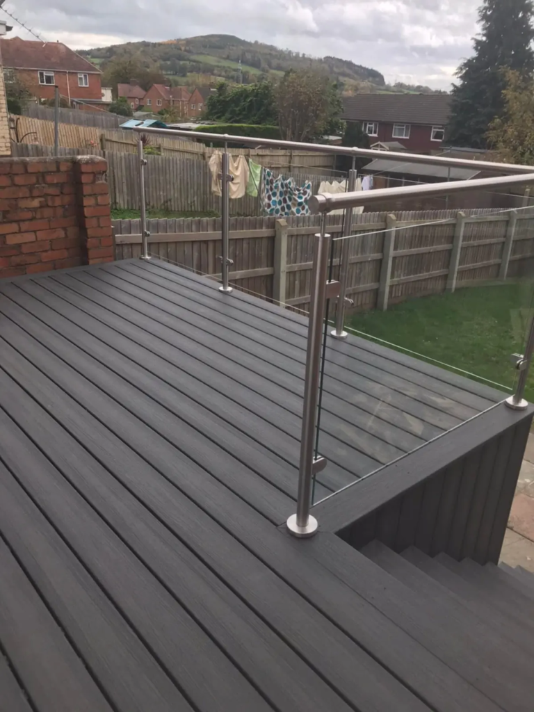 Raised composite balcony deck with a glass balustrade and views