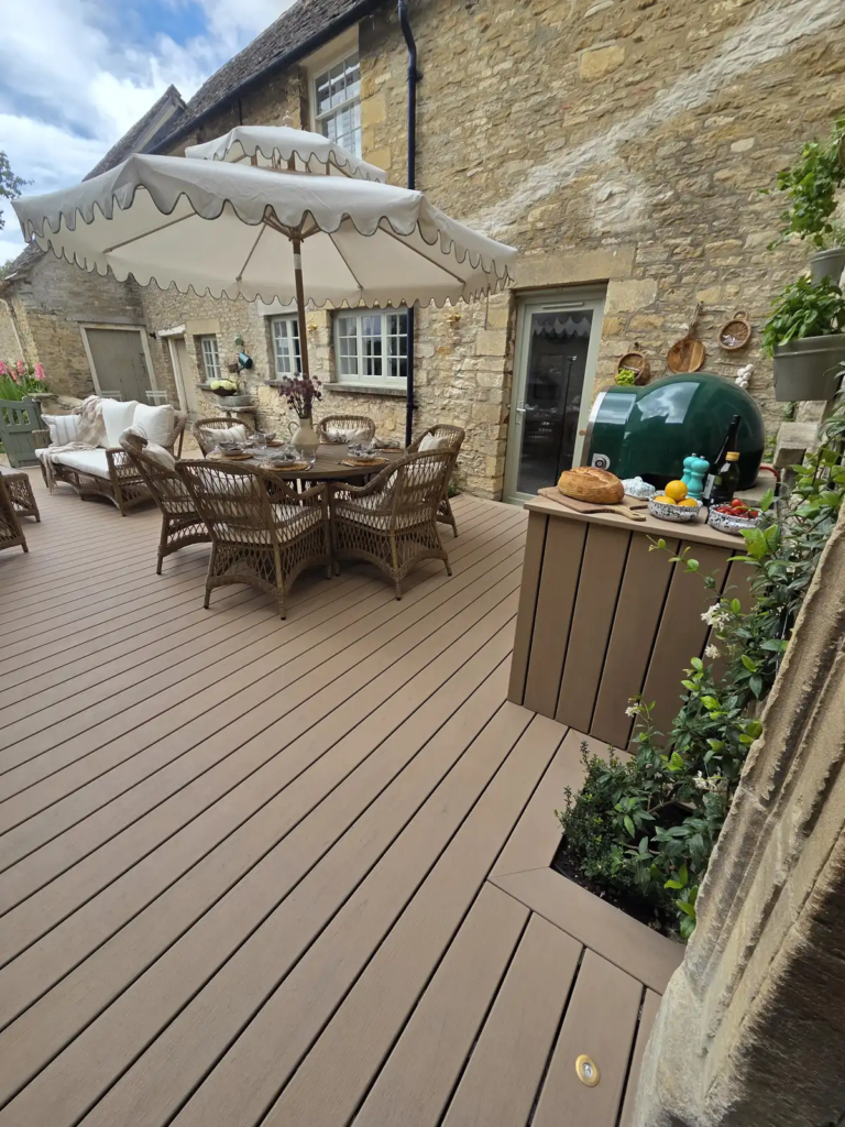 Outdoor kitchen and dining area on a curved Trex deck
