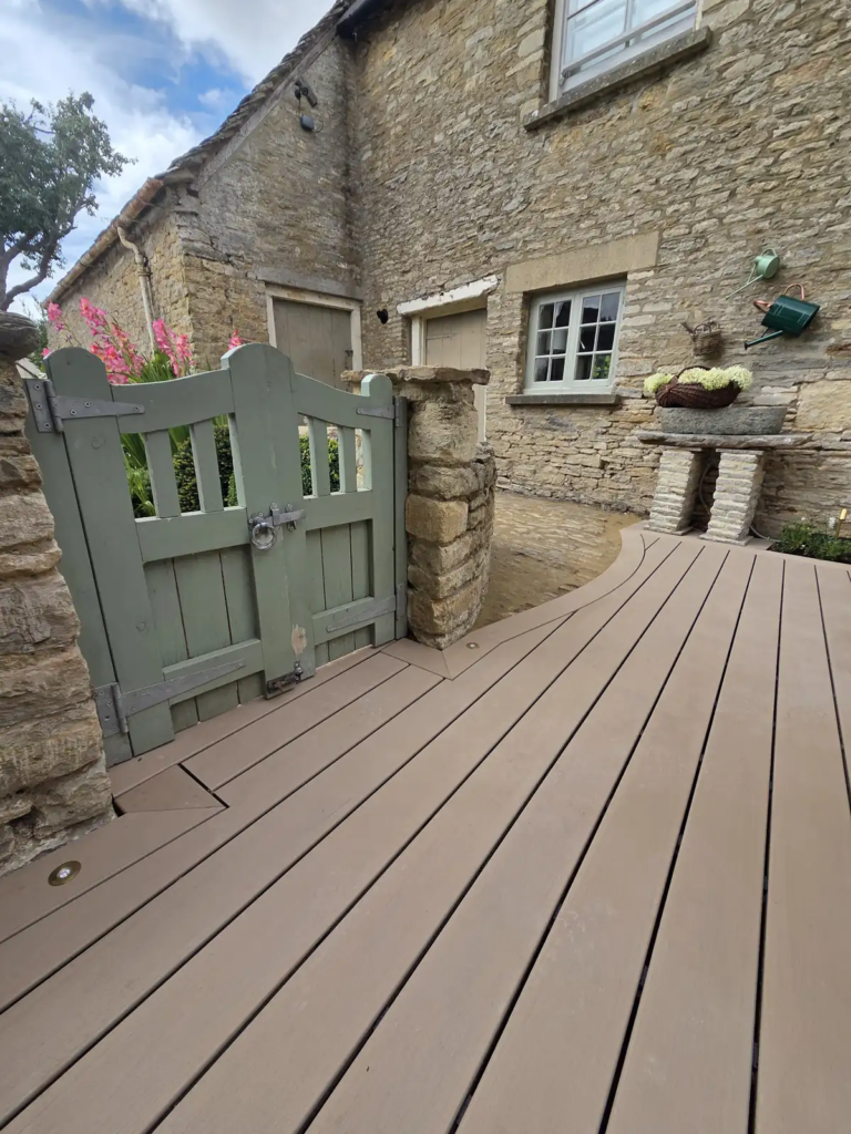 Garden gate opening onto the curved Trex deck