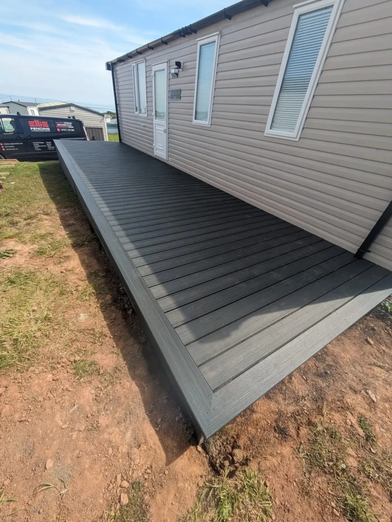 Long Trex composite deck running the length of a static caravan in Port Eynon
