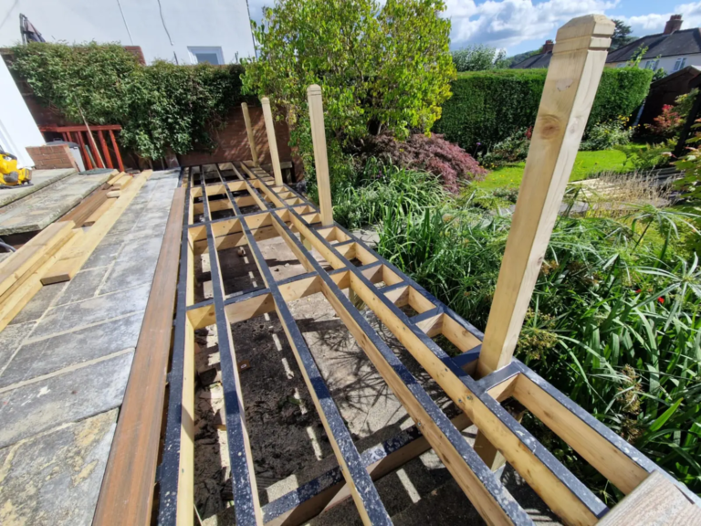 Taped joists and posts on a raised composite deck frame