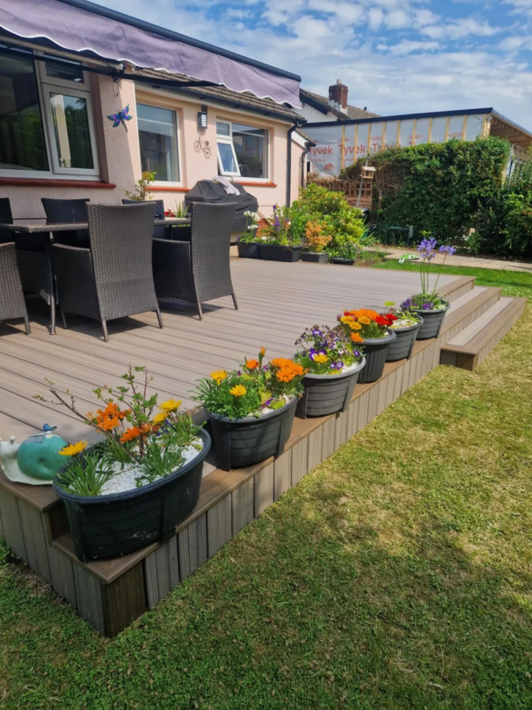 Finished Trex composite deck with planters and outdoor dining