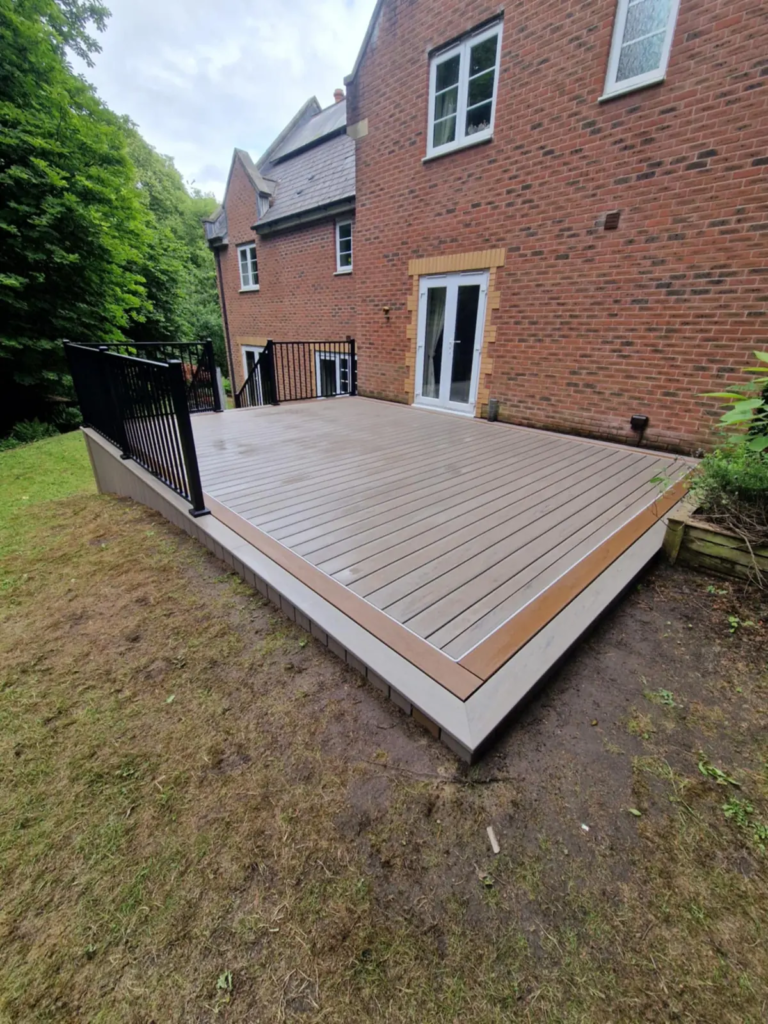 Trex composite garden deck on the lawn of a brick house