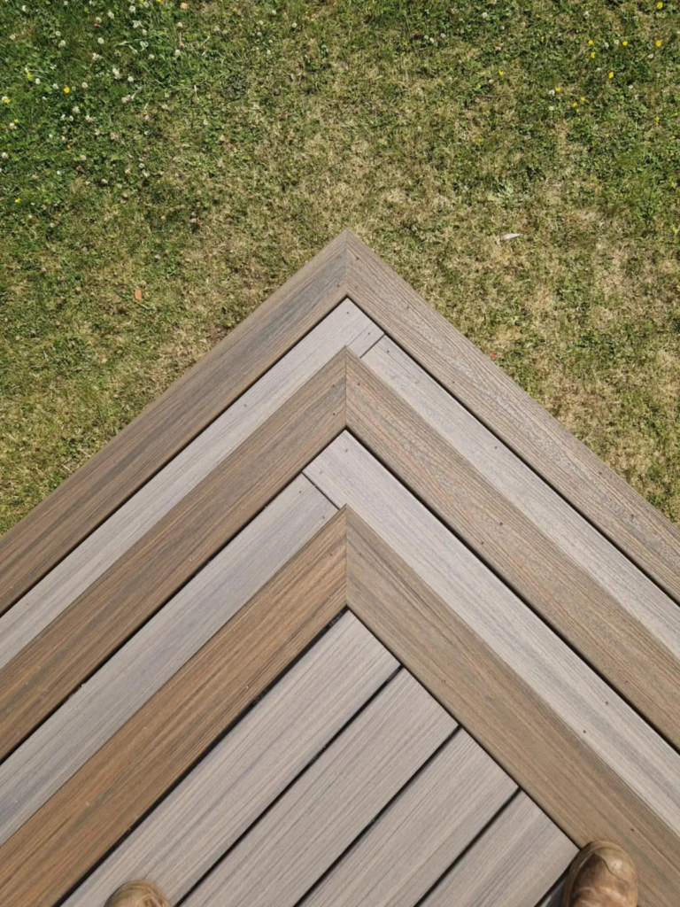 Mitred picture-frame border on the corner of a Trex deck